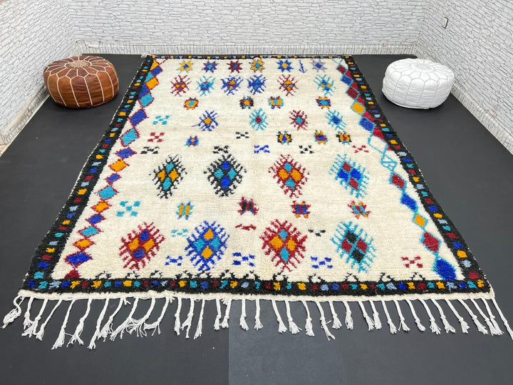 Handwoven Moroccan wool rug with colorful Berber tribal patterns and dark border