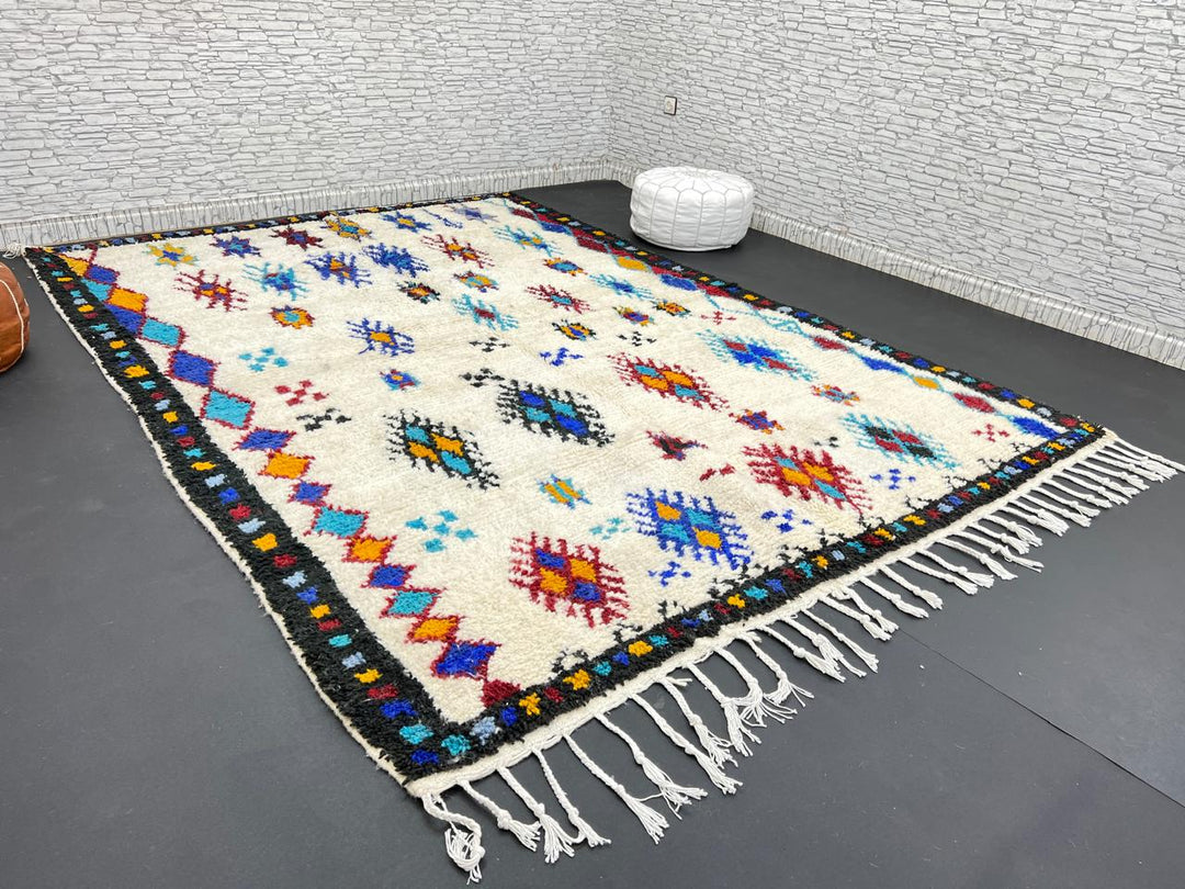 Handwoven Moroccan wool rug with colorful Berber tribal patterns and dark border