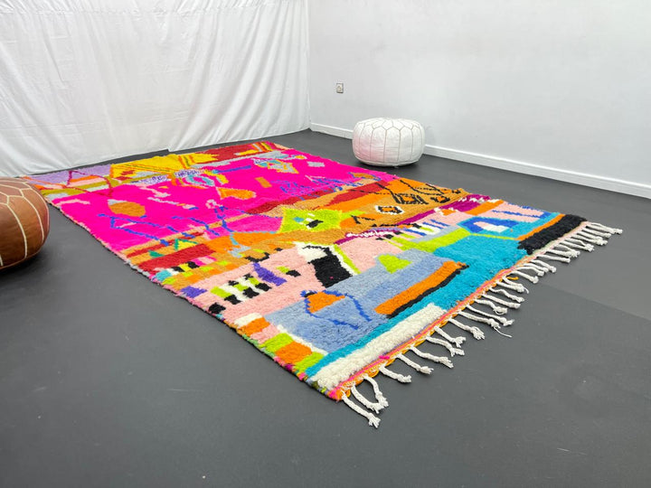 Collector Moroccan wool rug with vibrant abstract Berber patterns on a magenta pink background