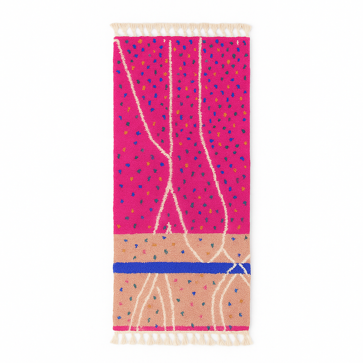 Handmade Moroccan runner rug with vibrant pink background, multicolor dotted accents, and abstract white and blue line design, crafted from natural wool.
