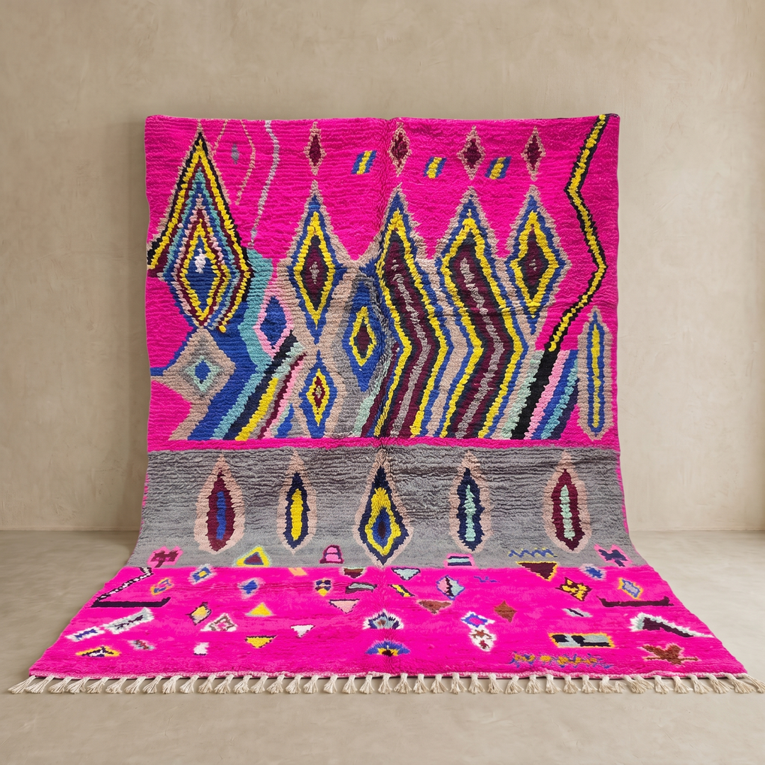 Vibrant pink Moroccan Berber rug with colorful tribal diamond patterns
