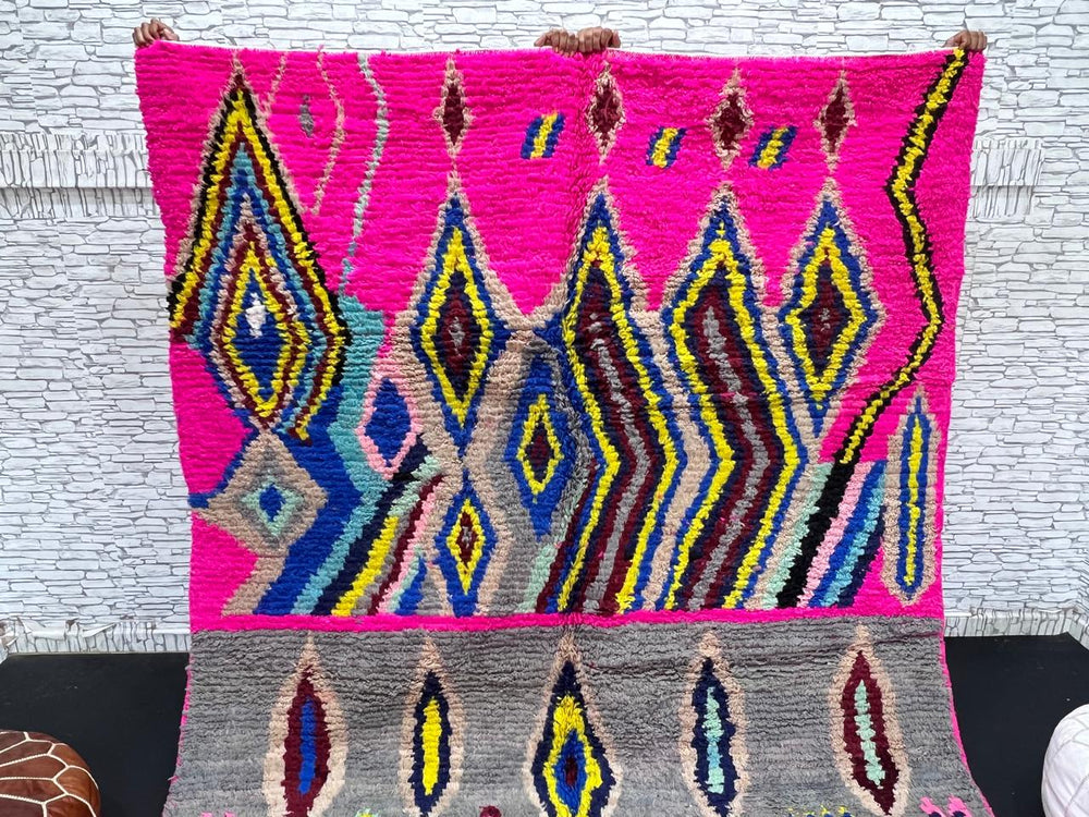 Vibrant pink Moroccan Berber rug with colorful tribal diamond patterns
