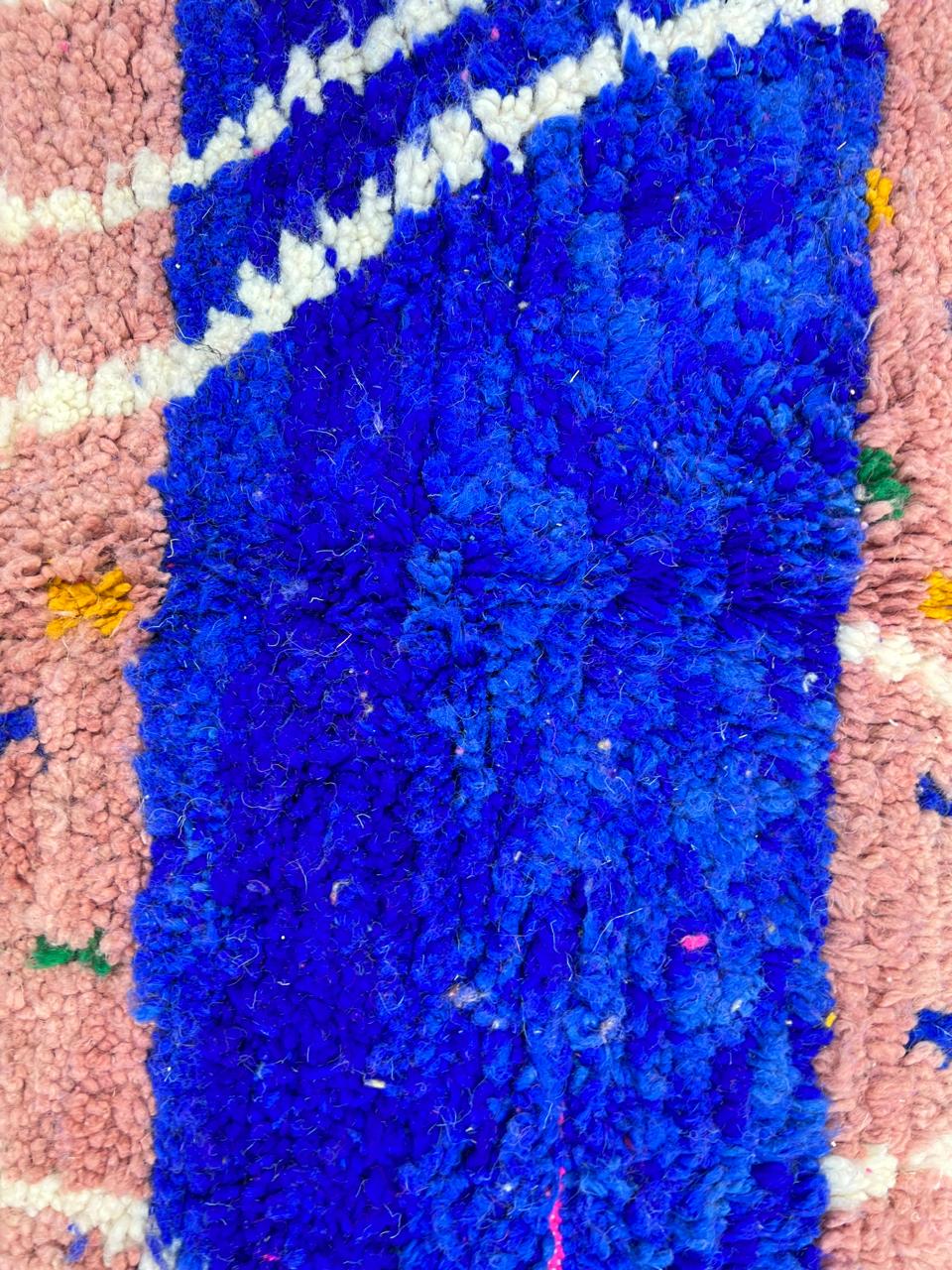 Handmade Moroccan runner rug with vibrant pink background, multicolor dotted accents, and abstract white and blue line design, crafted from natural wool.