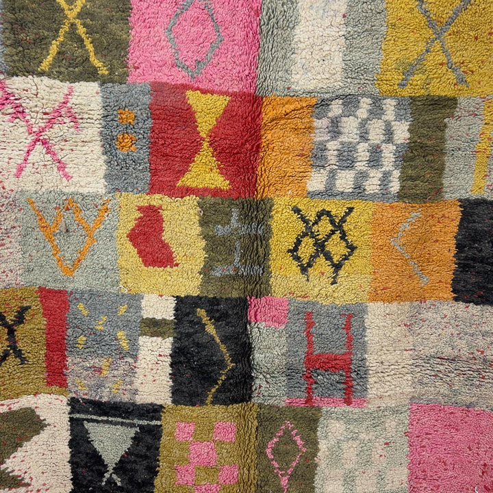 Handmade Moroccan Berber rug 95 with patchwork design in pink, mustard, and neutral tones, wool tribal carpet with geometric symbols