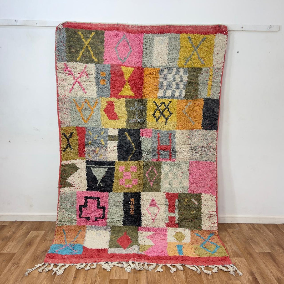 Handmade Moroccan Berber rug 95 with patchwork design in pink, mustard, and neutral tones, wool tribal carpet with geometric symbols