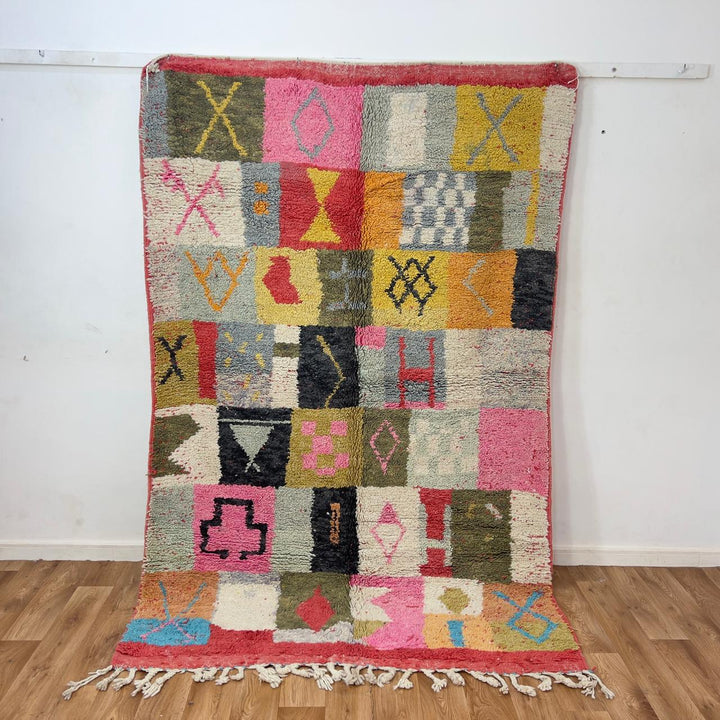 Handmade Moroccan Berber rug 95 with patchwork design in pink, mustard, and neutral tones, wool tribal carpet with geometric symbols