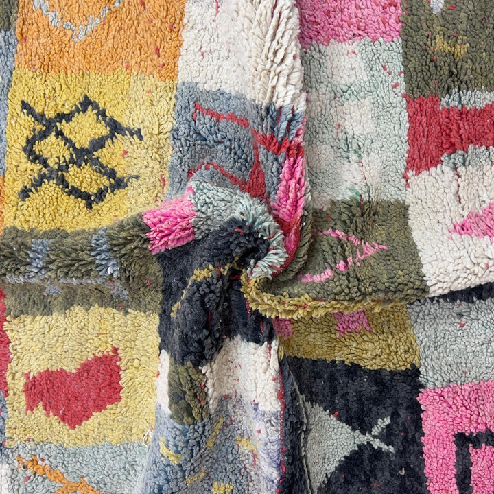 Handmade Moroccan Berber rug 95 with patchwork design in pink, mustard, and neutral tones, wool tribal carpet with geometric symbols