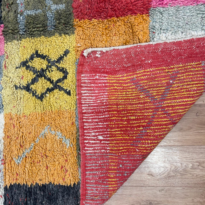 Handmade Moroccan Berber rug 95 with patchwork design in pink, mustard, and neutral tones, wool tribal carpet with geometric symbols