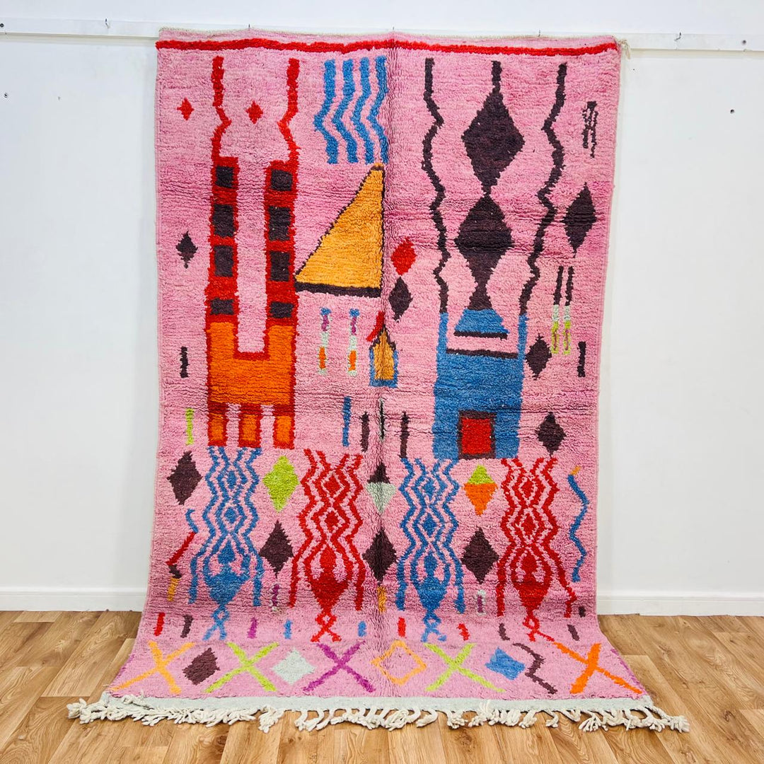 Vintage Moroccan Berber rug with pink base, colorful geometric tribal patterns, handmade wool carpet from Morocco