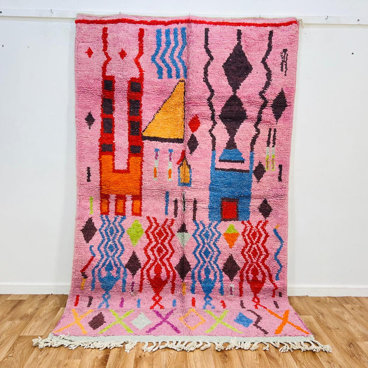 Vintage Moroccan Berber rug with pink base, colorful geometric tribal patterns, handmade wool carpet from Morocco
