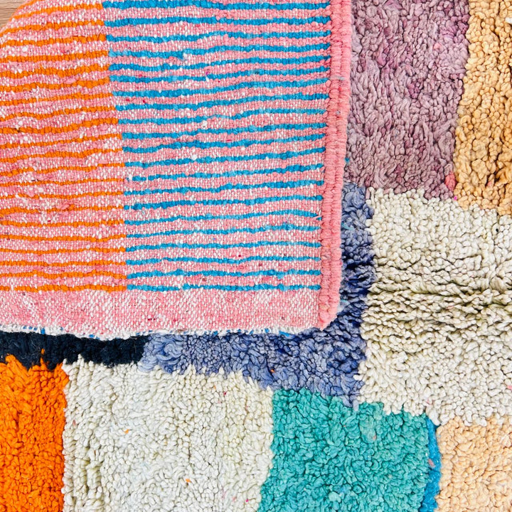Vintage Moroccan patchwork rug handmade from natural wool with colorful Berber squares