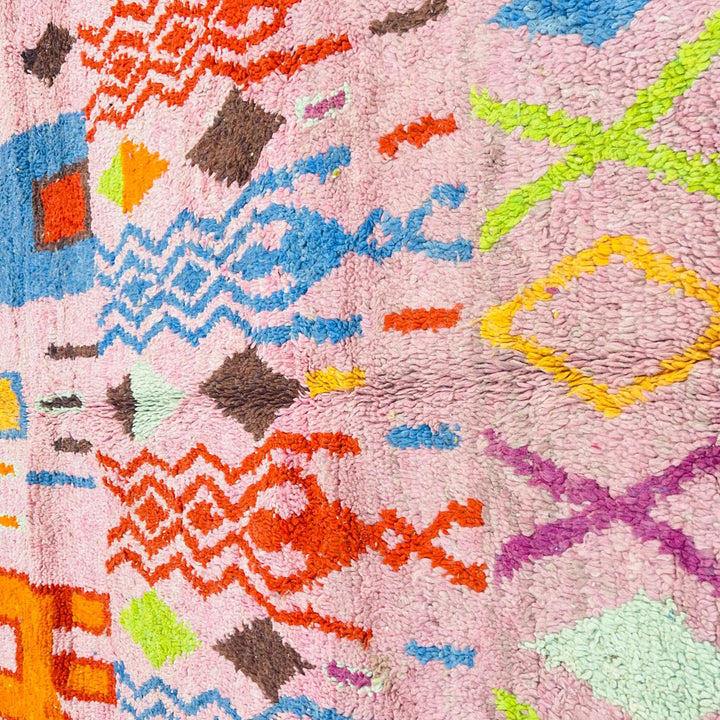 Vintage Moroccan Berber rug with pink base, colorful geometric tribal patterns, handmade wool carpet from Morocco