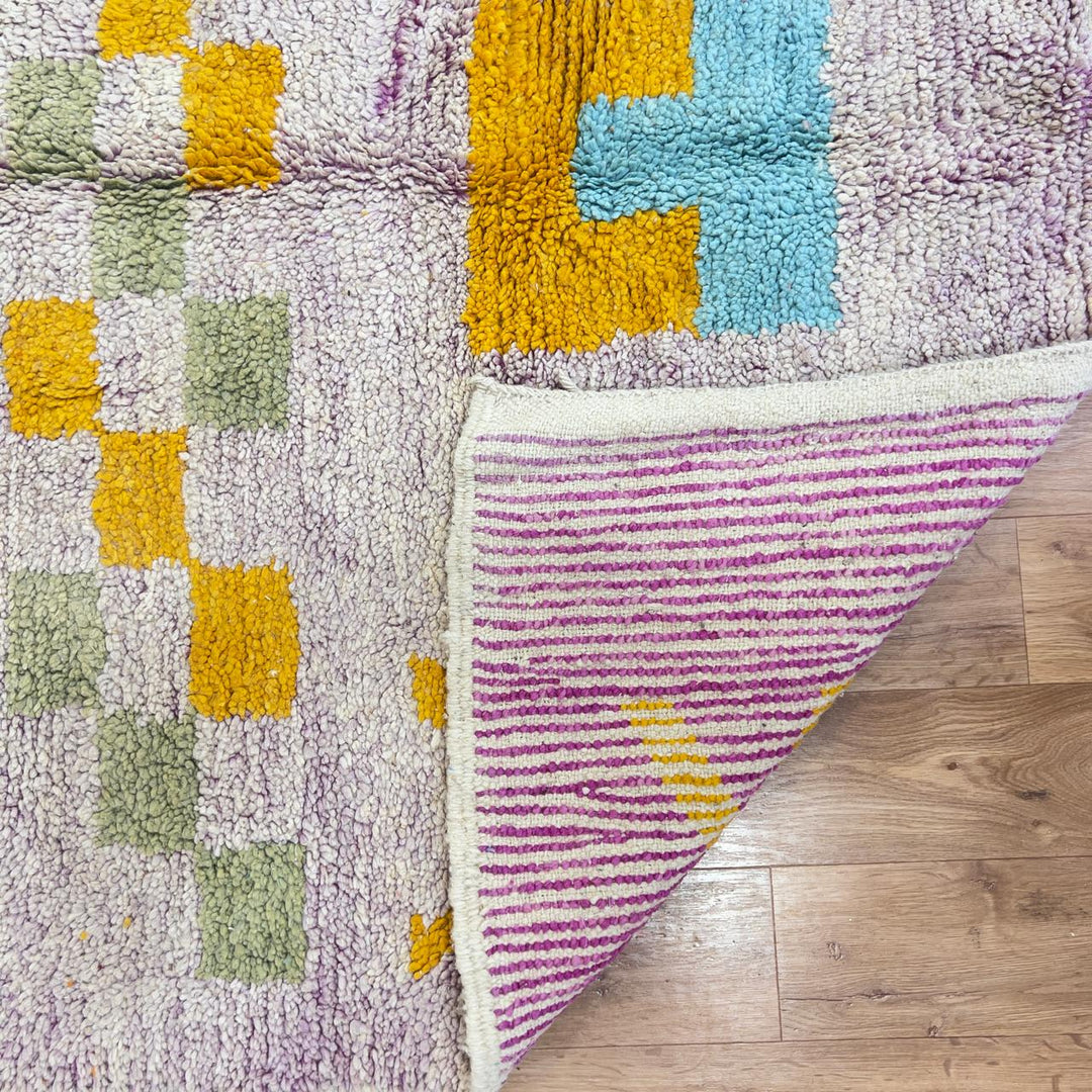 Vintage Moroccan wool rug with neutral base and colorful Berber geometric patterns