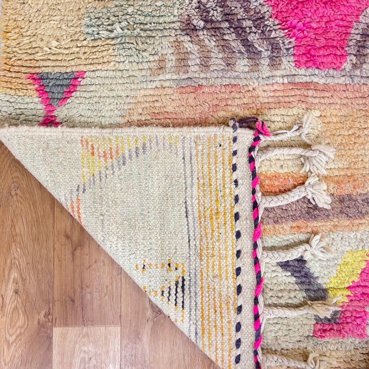 Large vintage Moroccan wool rug with abstract tribal symbols in beige, pink, and purple handmade Berber carpet