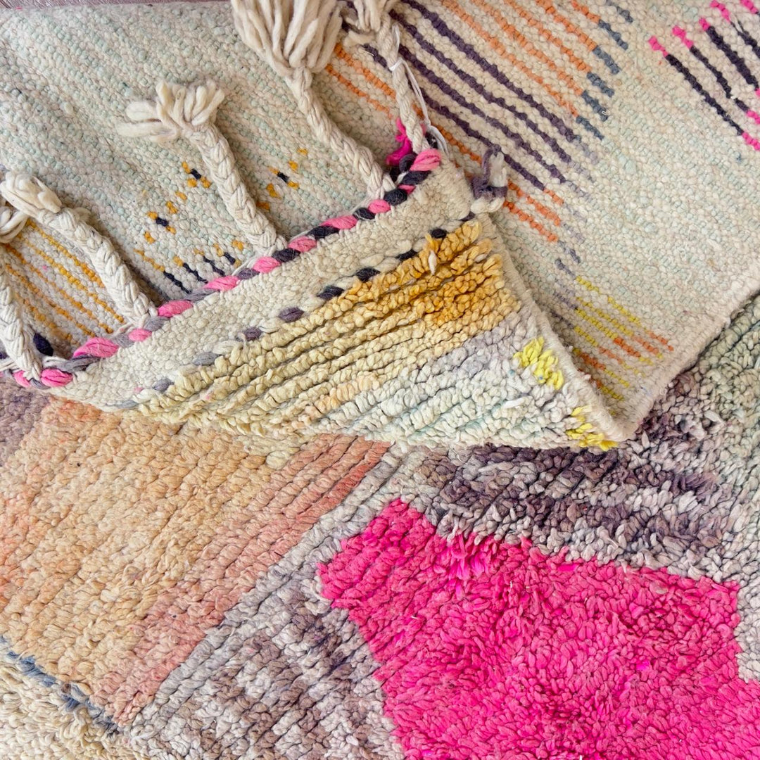 Large vintage Moroccan wool rug with abstract tribal symbols in beige, pink, and purple handmade Berber carpet