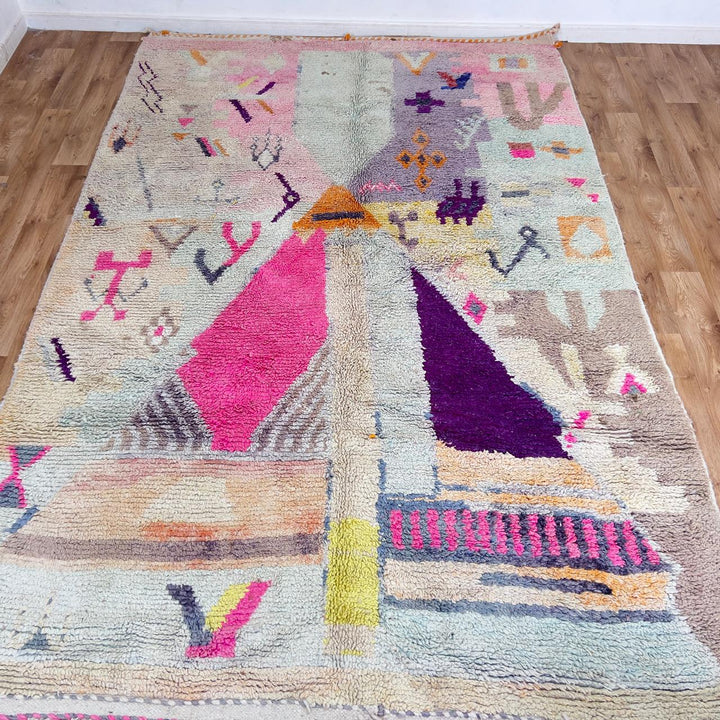 Large vintage Moroccan wool rug with abstract tribal symbols in beige, pink, and purple handmade Berber carpet