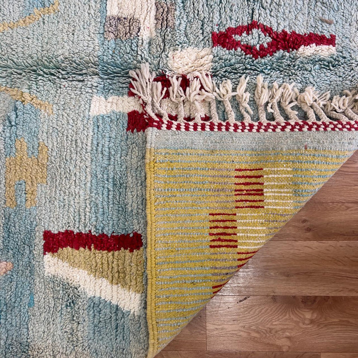 Vintage Moroccan wool rug with striped and tribal patterns in blue, cream, and red tones, handmade Berber carpet 8x5 ft