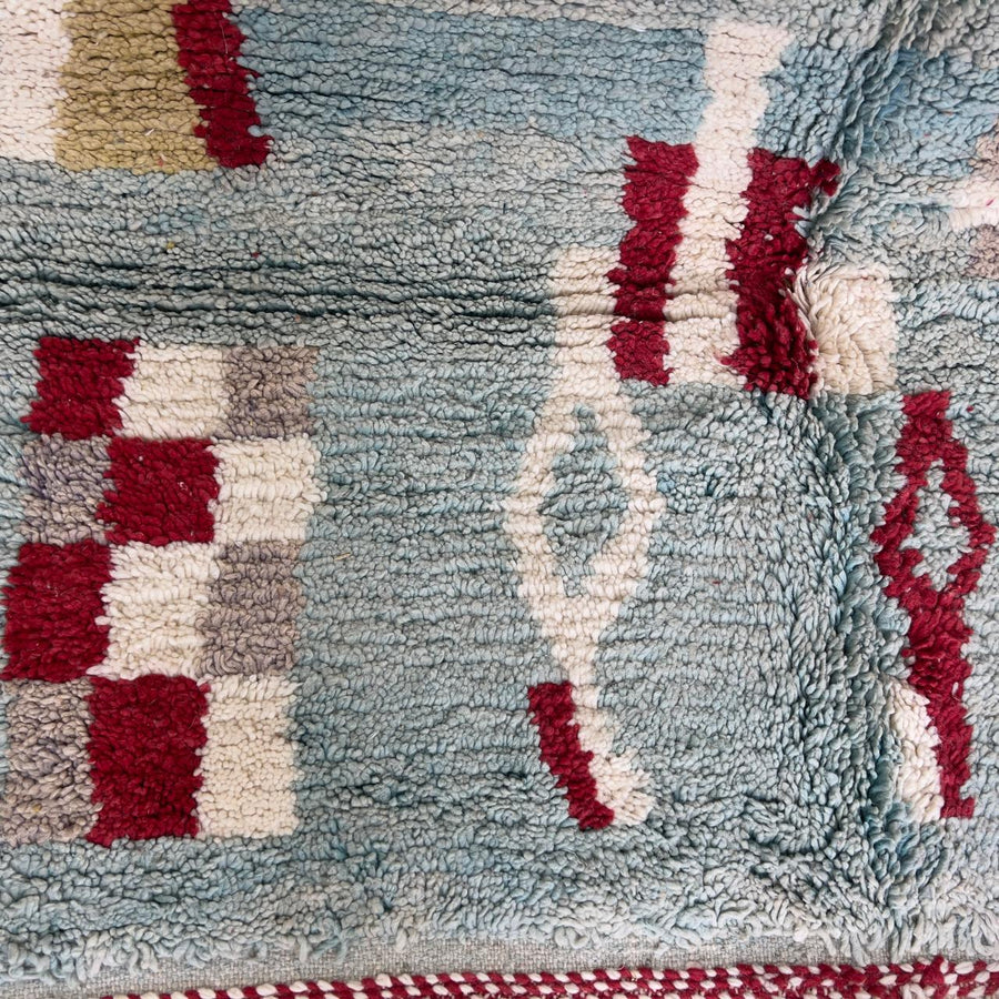 Vintage Moroccan wool rug with striped and tribal patterns in blue, cream, and red tones, handmade Berber carpet 8x5 ft