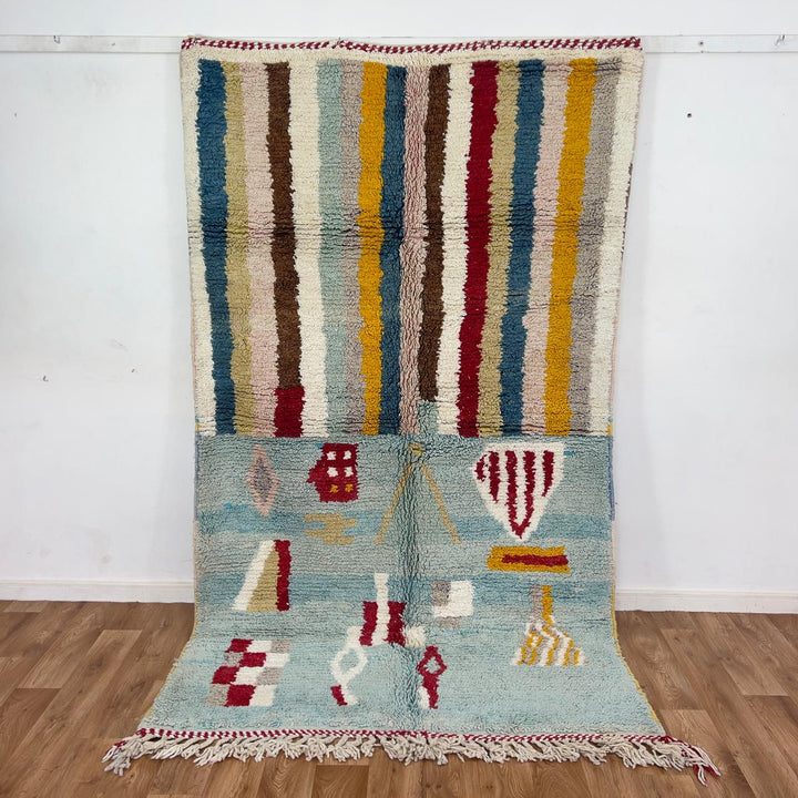 Vintage Moroccan wool rug with striped and tribal patterns in blue, cream, and red tones, handmade Berber carpet 8x5 ft