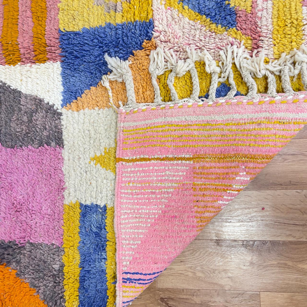 Vintage Moroccan wool rug with colorful geometric design in yellow, pink, blue, and ivory tones