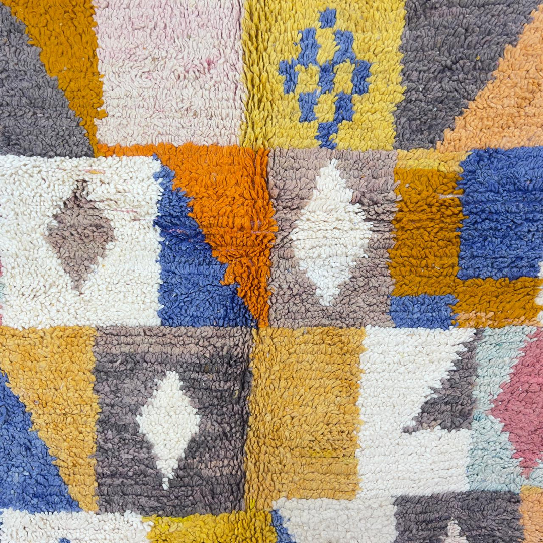 Vintage Moroccan wool rug with colorful geometric design in yellow, pink, blue, and ivory tones