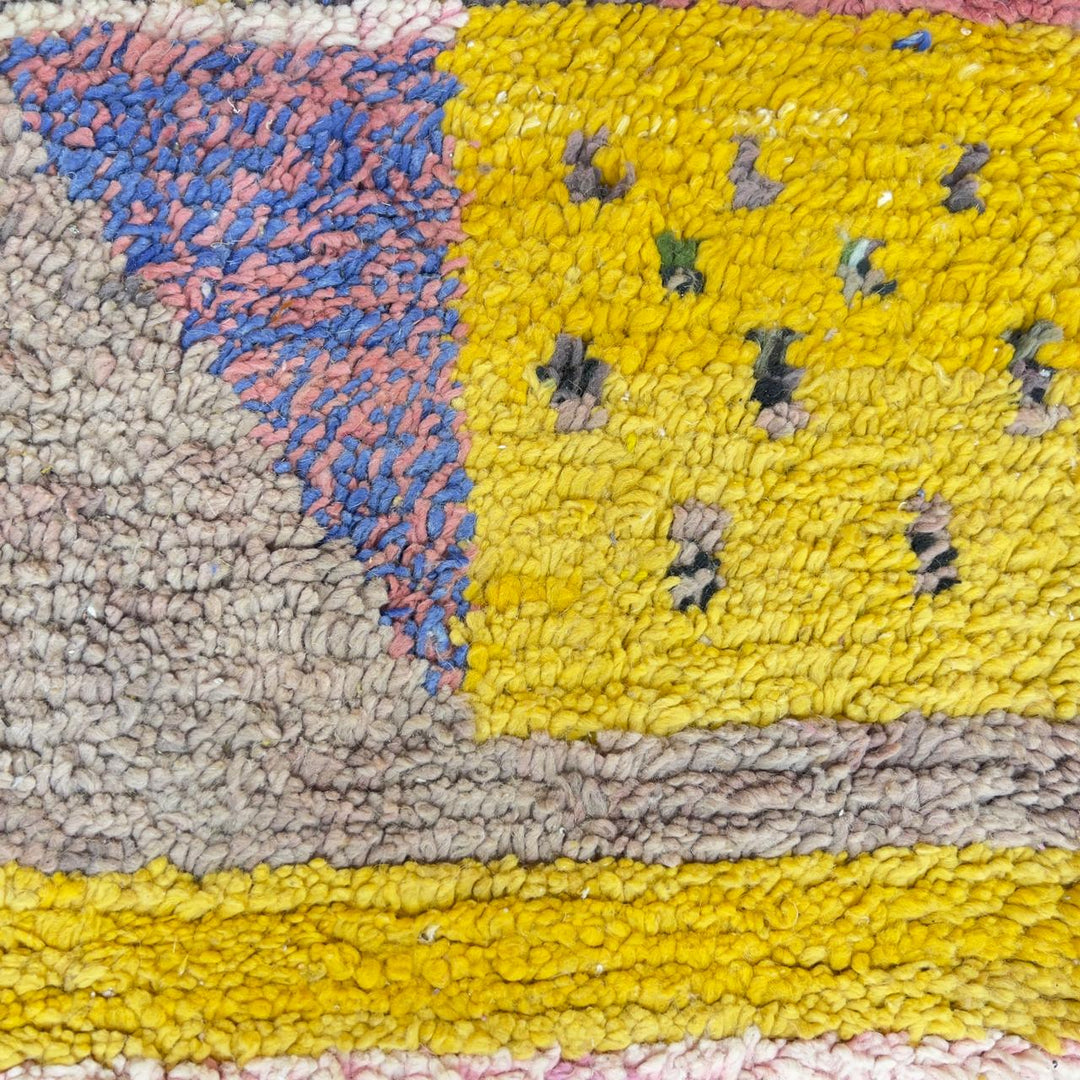 Vintage Moroccan wool rug with colorful geometric design in yellow, pink, blue, and ivory tones