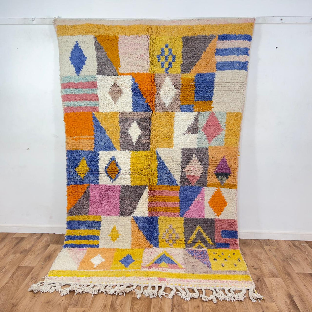 Vintage Moroccan wool rug with colorful geometric design in yellow, pink, blue, and ivory tones