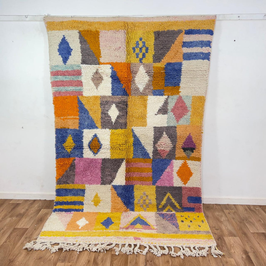 Vintage Moroccan wool rug with colorful geometric design in yellow, pink, blue, and ivory tones