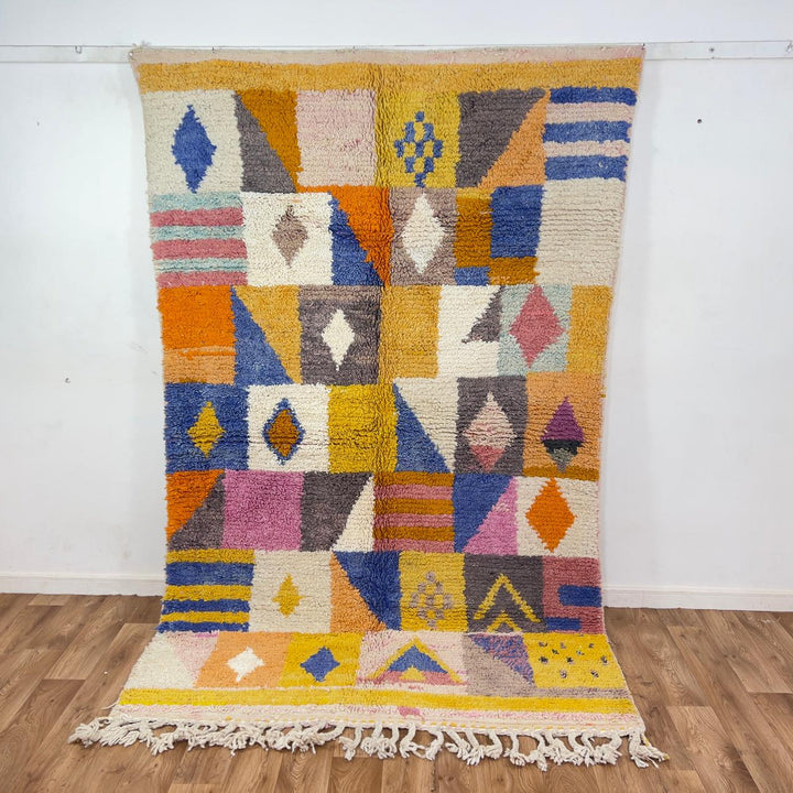 Vintage Moroccan wool rug with colorful geometric design in yellow, pink, blue, and ivory tones