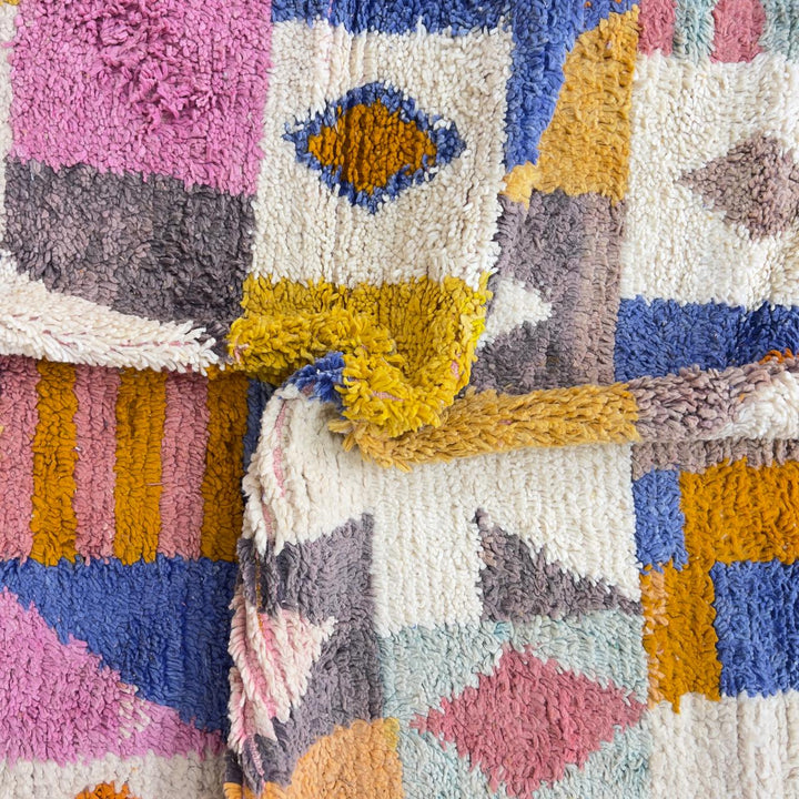 Vintage Moroccan wool rug with colorful geometric design in yellow, pink, blue, and ivory tones
