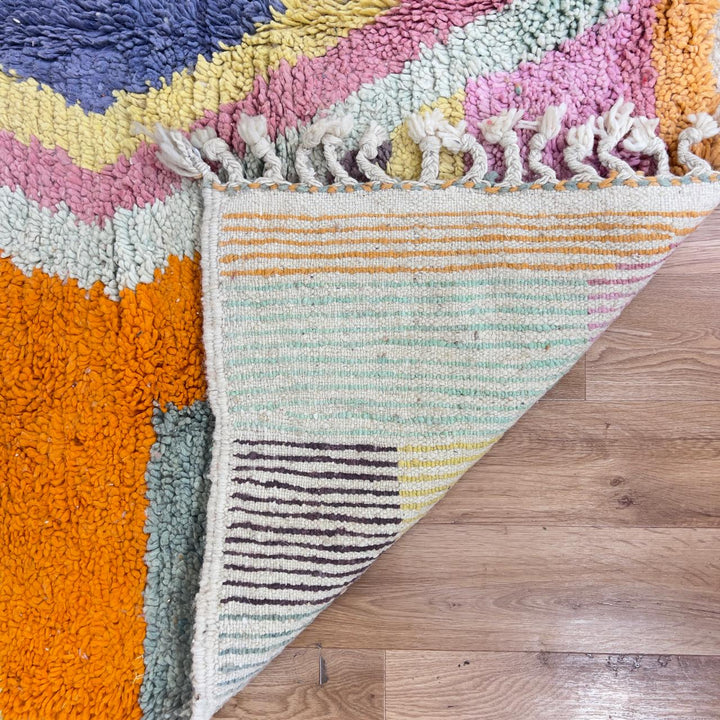 Vintage Moroccan wool rug with pastel geometric blocks and central diamond motif handmade Berber rug