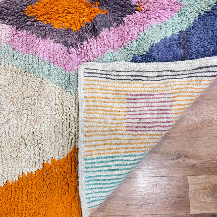 Vintage Moroccan wool rug with pastel geometric blocks and central diamond motif handmade Berber rug