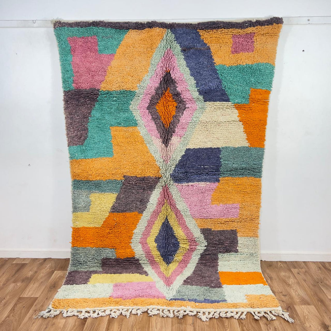 Vintage Moroccan wool rug with pastel geometric blocks and central diamond motif handmade Berber rug