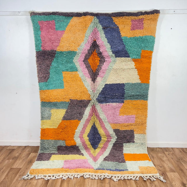 Vintage Moroccan wool rug with pastel geometric blocks and central diamond motif handmade Berber rug