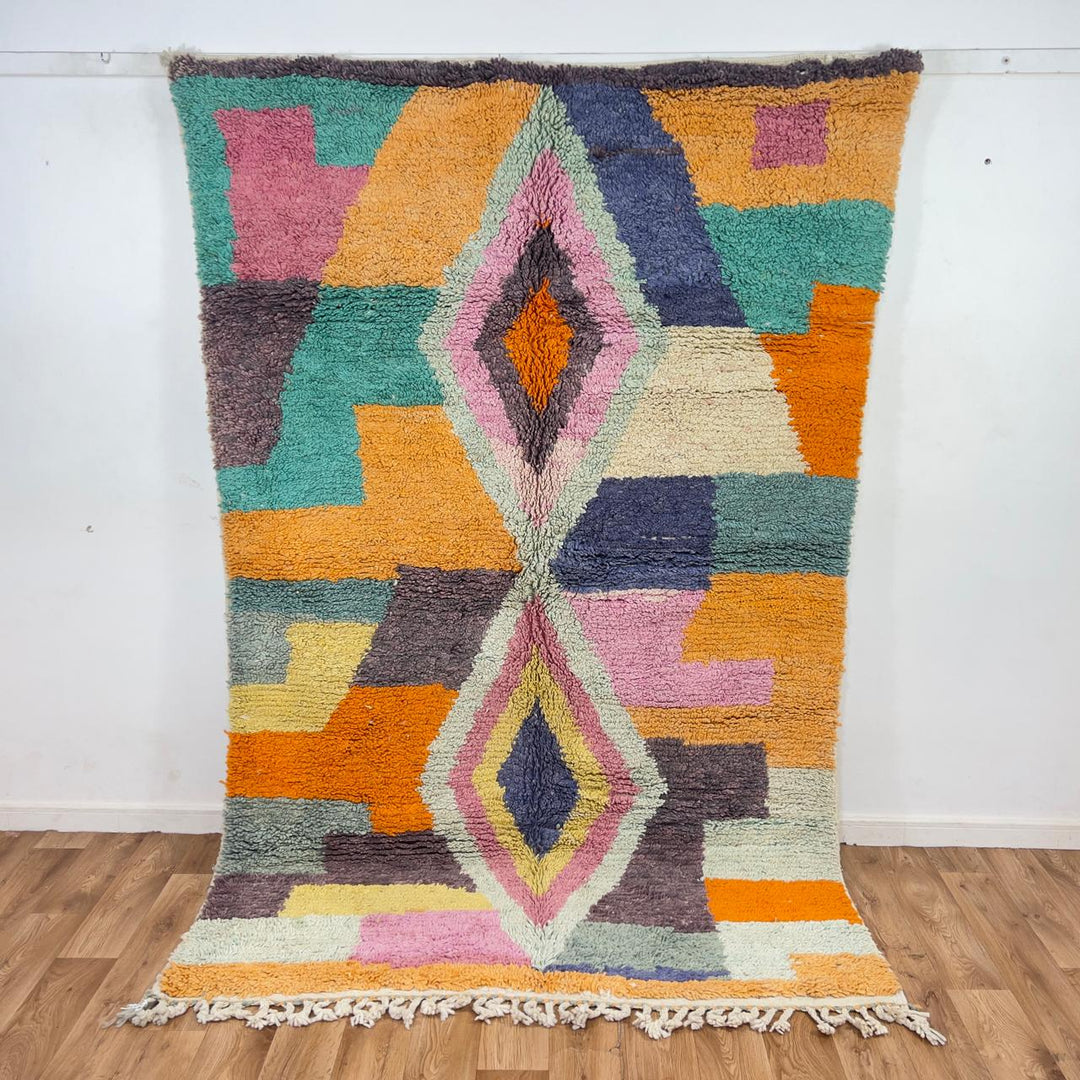 Vintage Moroccan wool rug with pastel geometric blocks and central diamond motif handmade Berber rug