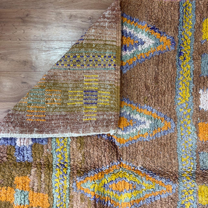 Vintage Moroccan wool rug with colorful Berber geometric patterns on brown background, handmade tribal carpet 8x5 ft