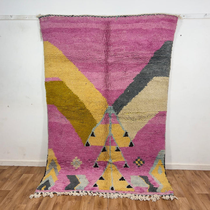 Vintage Moroccan wool rug in vibrant pink with geometric Berber patterns in mustard, beige, and charcoal, handmade shag rug