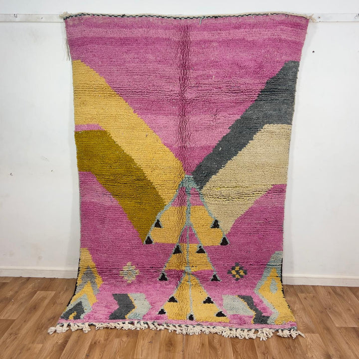 Vintage Moroccan wool rug in vibrant pink with geometric Berber patterns in mustard, beige, and charcoal, handmade shag rug