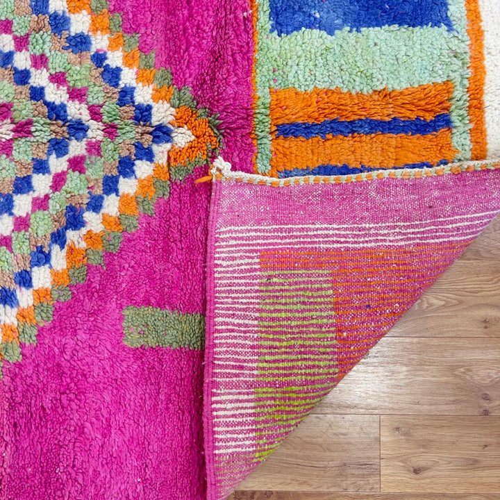 Vintage Moroccan wool rug with pink base and colorful geometric tribal patterns