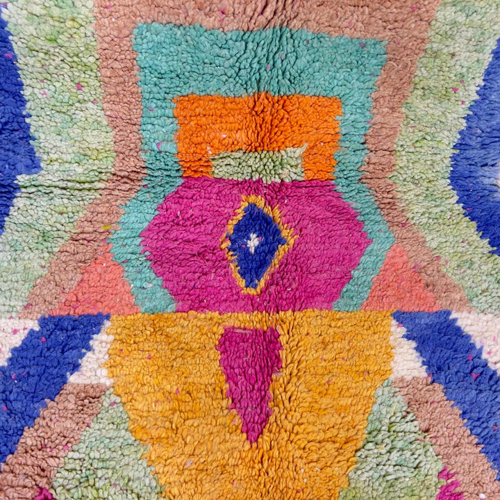 Vintage Moroccan wool rug with pink base and colorful geometric tribal patterns