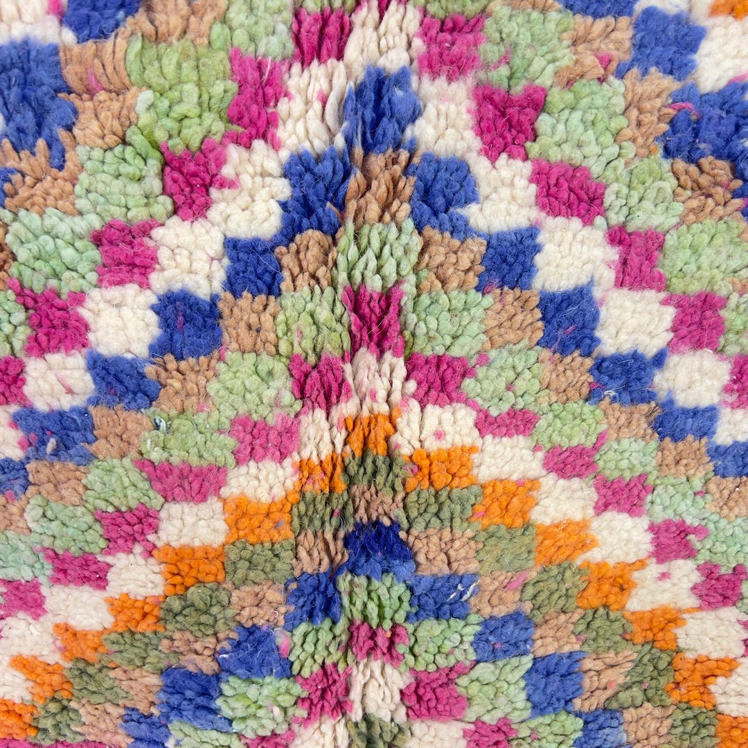 Vintage Moroccan wool rug with pink base and colorful geometric tribal patterns
