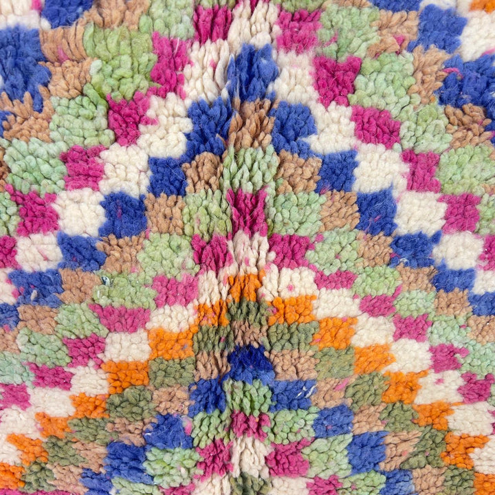 Vintage Moroccan wool rug with pink base and colorful geometric tribal patterns