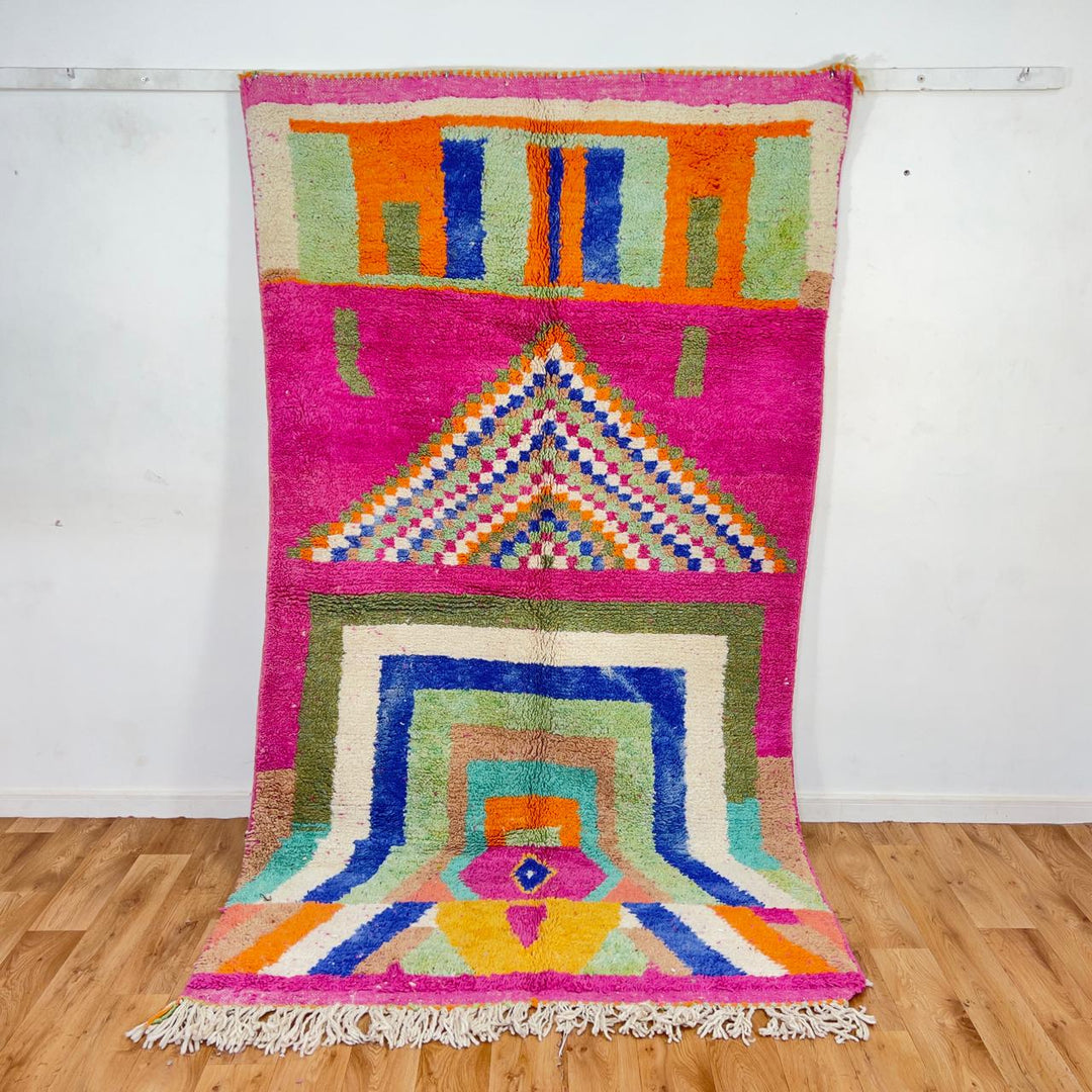 Vintage Moroccan wool rug with pink base and colorful geometric tribal patterns