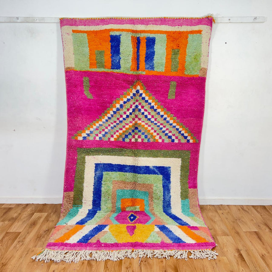 Vintage Moroccan wool rug with pink base and colorful geometric tribal patterns
