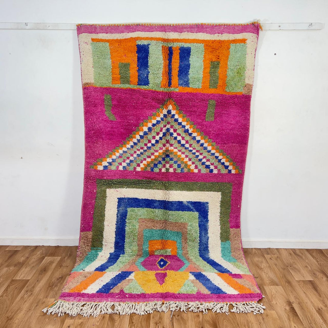Vintage Moroccan wool rug with pink base and colorful geometric tribal patterns