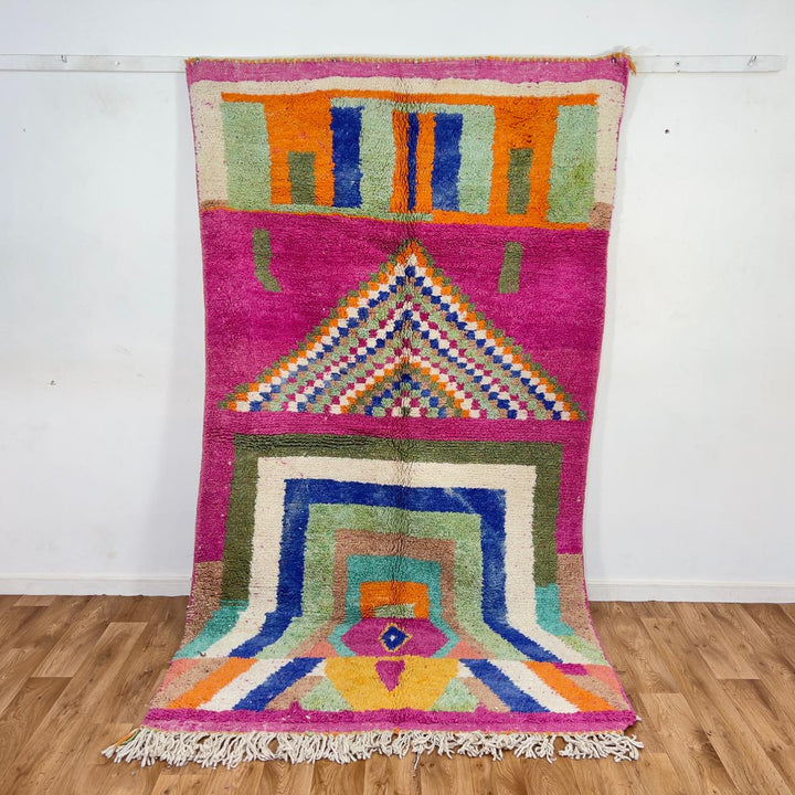 Vintage Moroccan wool rug with pink base and colorful geometric tribal patterns