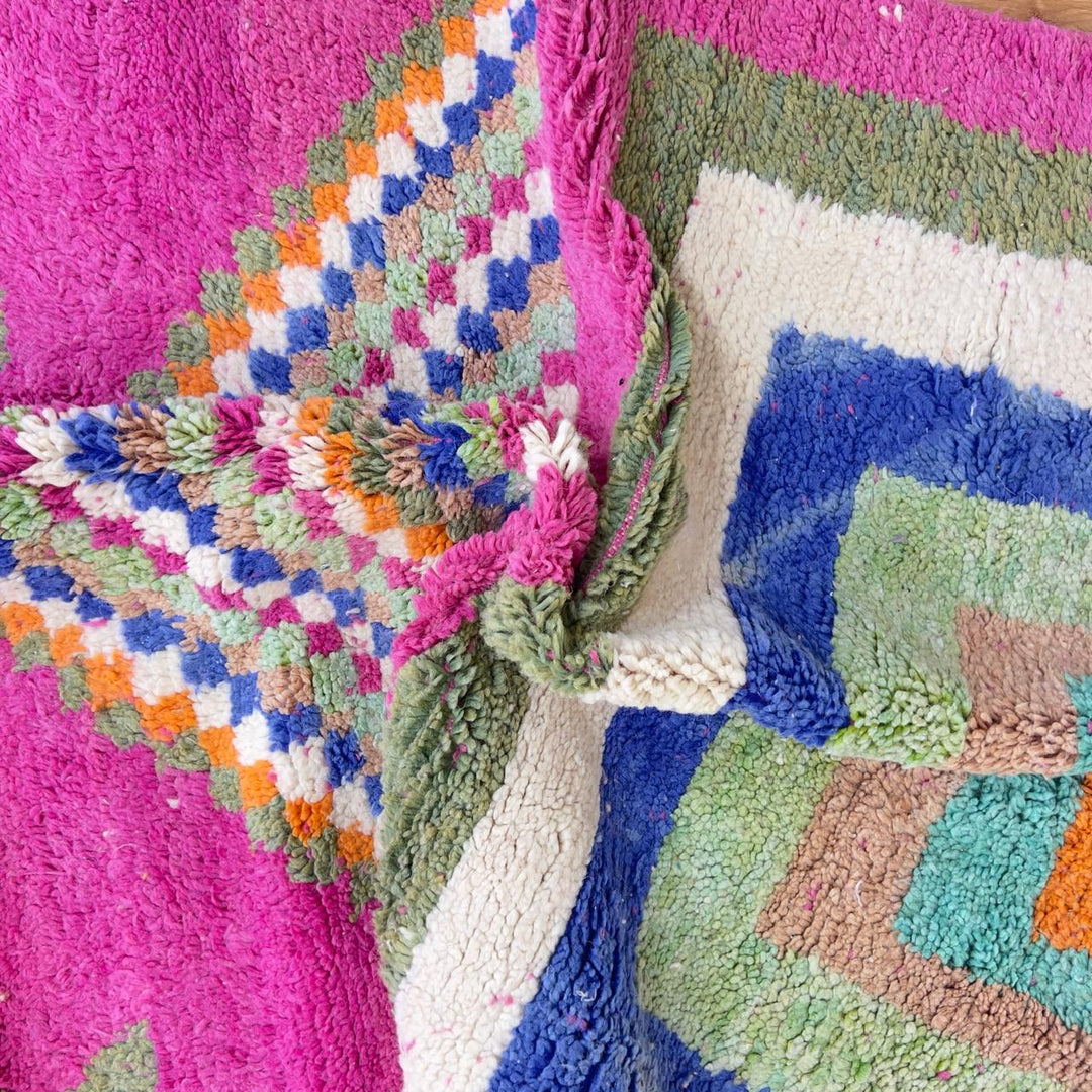 Vintage Moroccan wool rug with pink base and colorful geometric tribal patterns