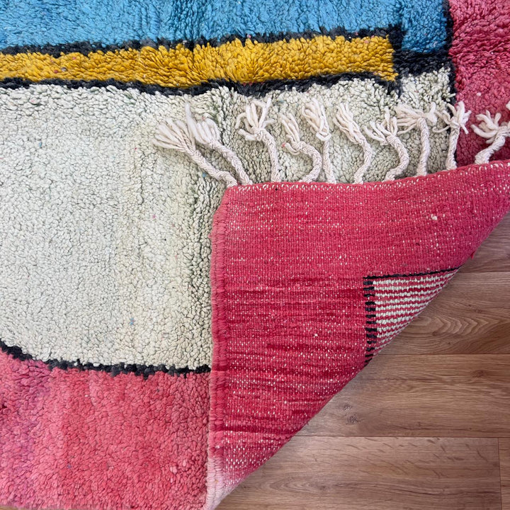 Vintage Moroccan wool rug 8.5 x 5.1 ft with abstract human figures design in pink blue and cream handmade Berber rug