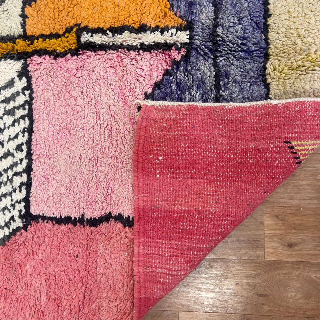 Vintage Moroccan wool rug 8.5 x 5.1 ft with abstract human figures design in pink blue and cream handmade Berber rug