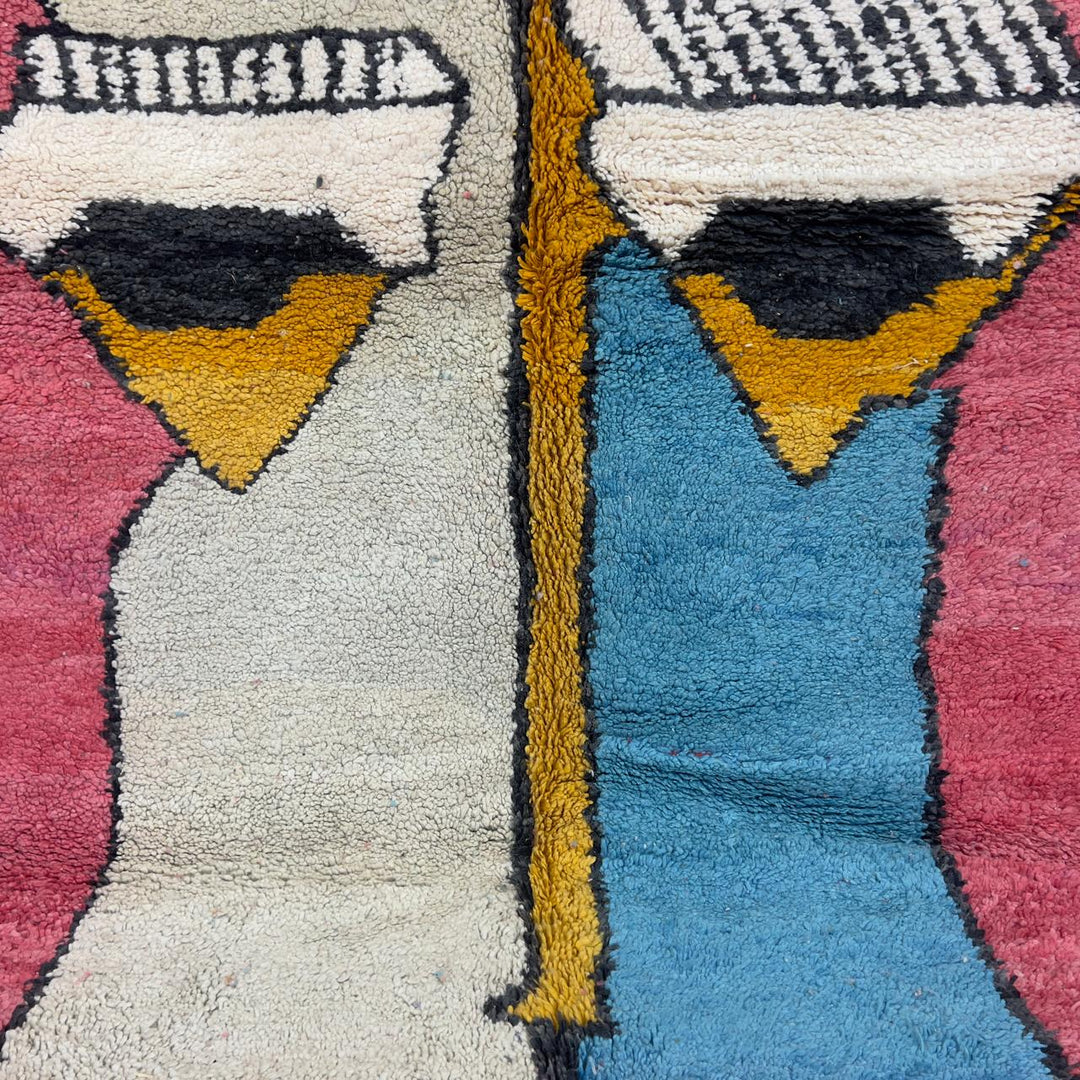 Vintage Moroccan wool rug 8.5 x 5.1 ft with abstract human figures design in pink blue and cream handmade Berber rug